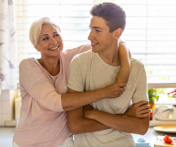 Mom and young adult son looking at each other