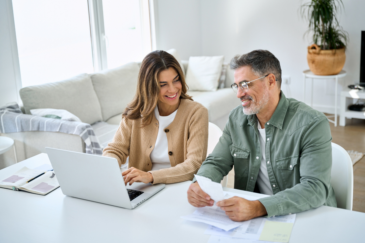 A high net worth couple reviewing a coordinated retirement strategy designed to reduce complexity and stress.